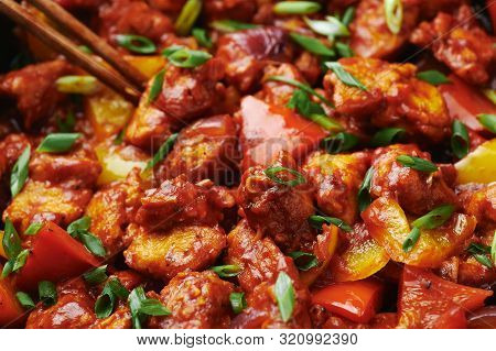Chicken Manchurian In Pan At Black Concrete Background. Chicken Manchurian Is Indian Chinese Cuisine