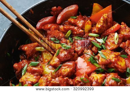 Chicken Manchurian In Pan At Black Concrete Background. Chicken Manchurian Is Indian Chinese Cuisine