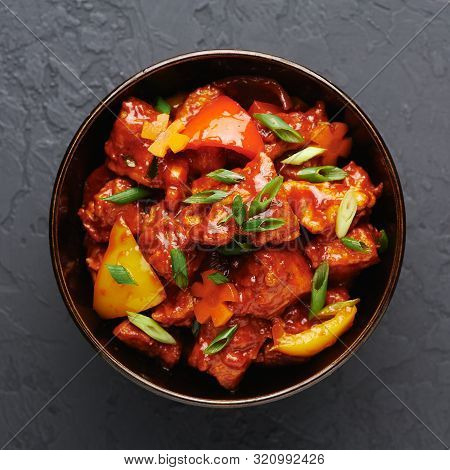 Chicken Manchurian In Pan At Black Concrete Background. Chicken Manchurian Is Indian Chinese Cuisine