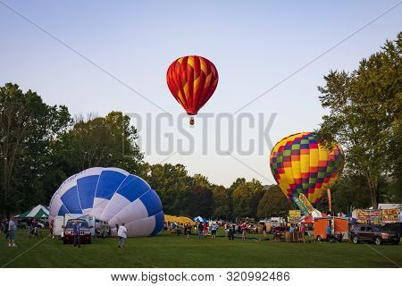 Festival Goers Watch Hot Air Balloons Take To Flight Early Saturday Morning, August 3, 2019 At The S