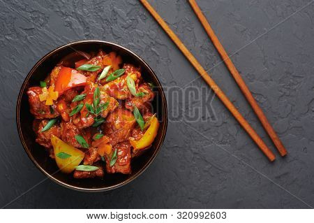 Chicken Manchurian In Pan At Black Concrete Background. Chicken Manchurian Is Indian Chinese Cuisine