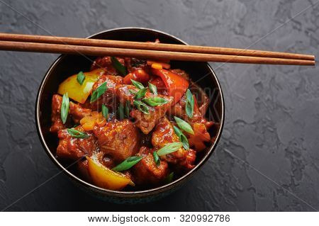 Chicken Manchurian In Pan At Black Concrete Background. Chicken Manchurian Is Indian Chinese Cuisine