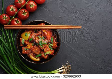Chicken Manchurian In Pan At Black Concrete Background. Chicken Manchurian Is Indian Chinese Cuisine