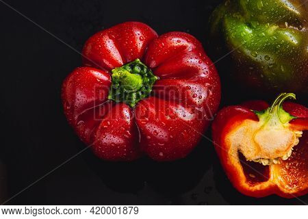Fresh Red Bell Pepper On Black Background. Top View Tropical Abstract Background. Cloe Up Pepper Veg