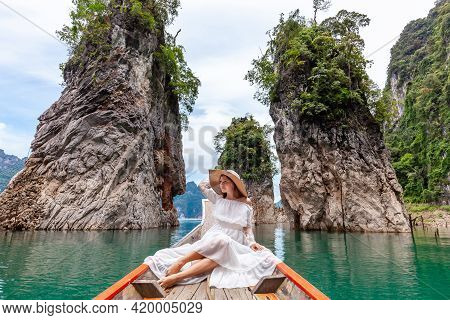 Young Female Tourist In Dress And Hat At Longtail Boat Near Famous Three Rocks With Limestone Cliffs