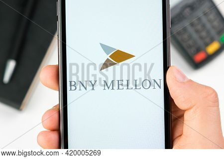 Bny Mellon Bank Logo On The Smartphone Screen In Mans Hand On The Background Of Payment Terminal, Ma
