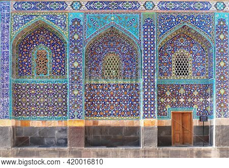Arches with mosaics at the entrance to Shrine Ensemble, mausoleum and khaneghah of Sheikh Safi al-din, Ardabil, Iran. Inscription at the wall - text from the Quran. UNESCO world heritage site