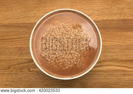 Cooking Pilaf In A Cauldron, A Recipe For Real Pilaf. Soak Rice In A Container Of Water Before Cooki