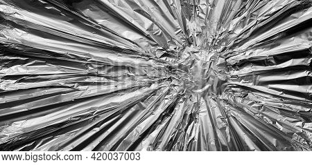 Metal Background As A Metalic And Silver Or Chrome Aloy Shaped As A Steel Banner In A Starburst Patt