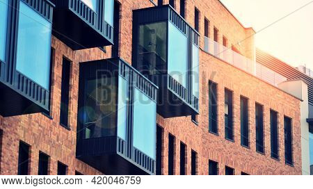 Modern Brick And Glass Facade Of The Office Building.  A Contrasting Combination Of Sky And Brick Te