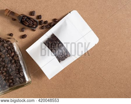Roasted Coffee Beans In White Transparent Window Paper Bag With Zipper And Wooden Scoop, Glass Bottl