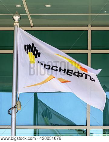 Samara, Russia - May 8, 2021: The Flag Of Oil Company Rosneft Against Office Building. Rosneft Is On