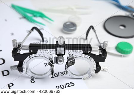 Trial Frame With Different Ophthalmologist Tools On White Background, Closeup