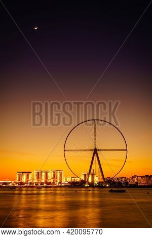 Twilight view of Bluewaters Island and Ain Dubai during construction, Dubai, UAE