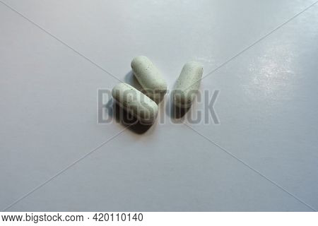 Punctate Pale Green Caplets Of Kelp Dietary Supplement (three Items)