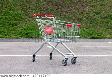 Empty Red Shopping Cart Or Trolley On Suppermarket Parking