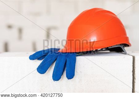 Builder Tools Lays Aerated Concrete Block At A Construction Site. Objects. Hemlet, Gloves, Water Lav