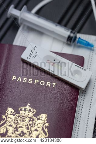 Covid-19, Travel And Lockdown Concept,passport With Covid-19 Rapid Test And Syringe For Vaccination