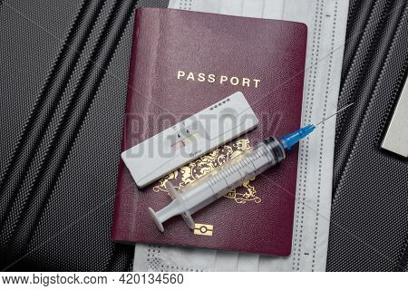 Covid-19, Travel And Lockdown Concept,passport With Covid-19 Rapid Test And Syringe For Vaccination
