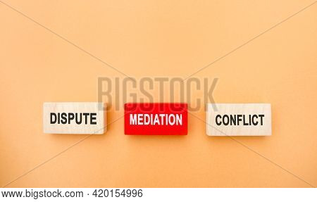 Wooden Blocks With The Word Dispute, Mediation, Conflict. Settlement Of Disputes By Mediation. Dispu