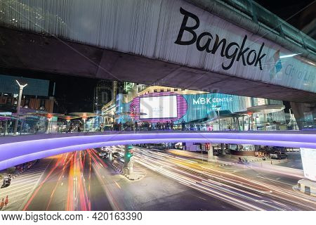 Bangkok Thailand , April 03 , 2021 : Bts Skytrain And Sky Walk Mbk Shopping Center With Car Lights O