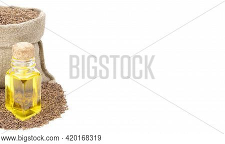 Cumin Essential Oil. Glass Bottle Of Cummin Oil. Caraway In A Sack Of Isolated On A White Background