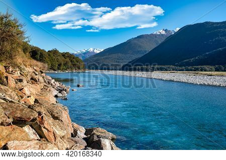 Meandering Makarora River Flowing Through The Tree Lined Valley In Mount Aspiring National Park