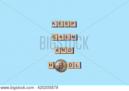 Keep Calm And Hodl Bitcoin, Funny Sign About Cryptocurrency With Wooden Blocks On Blue Background An