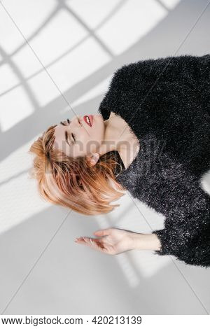 Brown hair woman in a black fluffy sweater