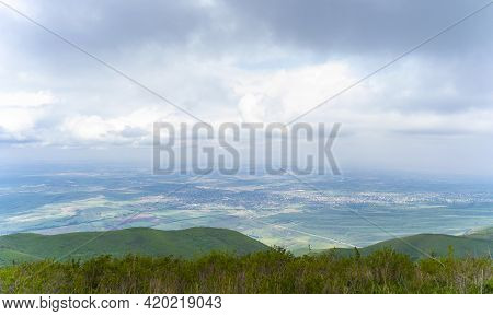 Beautiful View From The Green Hill With A Small Town Downhill. Ushkonyr Plateau, Almaty, Kazakhstan.