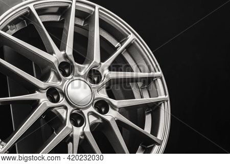 Sporty Lightweight Alloy Wheel, Spokes And Rim Close-up On A Black Background