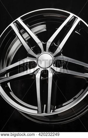 New Black Alloy Wheel Sports Car In The Shape Of A Five-pointed Star. Vertical Photo