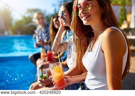 Pretty Woman Relax With Fresh Colorful Cocktail Glass Sitting By Swimming Pool On Sunny Summer Day W