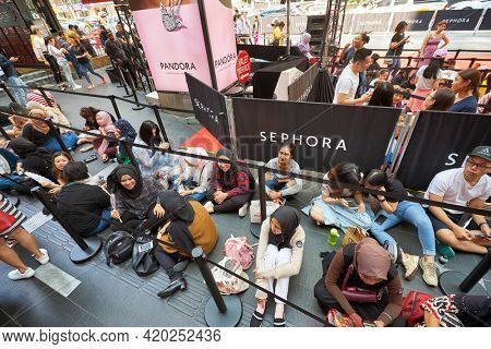 KUALA LUMPUR, MALAYSIA - JANUARY 18, 2020: people sit in line waiting for the grand opening of Sephora store at Fahrenheit 88 shopping mall in Kuala Lumpur.