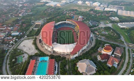 Aerial Top Down View Of The Beautiful Scenery Of Wibawa Mukti Stadium When Sunrise. With Bekasi City