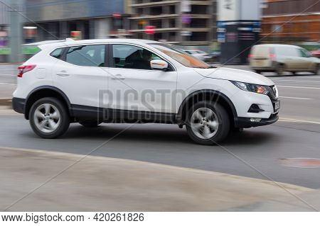 Nissan Qashqai Second Generation J11 Rides On City Road. Overspeed In City Concept. White Suv In A T