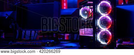 Top-end System Unit For Gaming Computer Close Up. Inside Of Illuminated Cybercafe, No People. Modern