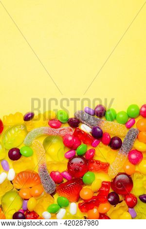 Candy Layout On A Yellow Background . Copy Space Candy. An Article About Sweets. Marmalade Candies. 