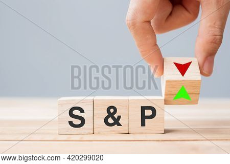 Business Man Hand Change Wood Cube Block With S&p Text To Up And Down Arrow Symbol Icon. Interest Ra