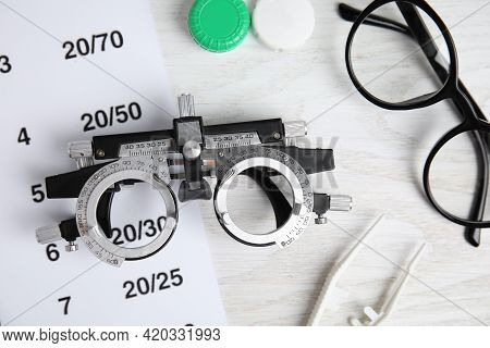 Different Ophthalmologist Tools On White Wooden Background, Flat Lay