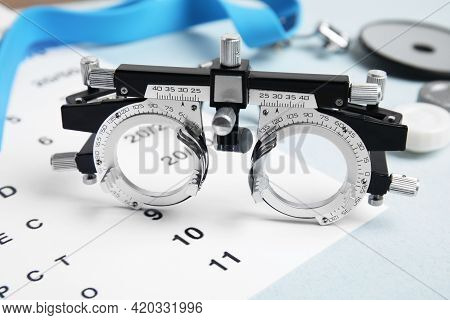Trial Frame With Different Ophthalmologist Tools On Grey Background, Closeup