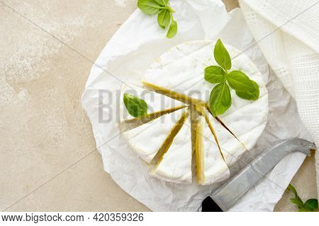 Camembert Cheese With Basil Leaves. Dairy Products