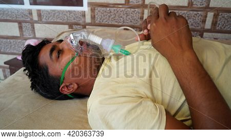 Young Indian Taking Emergency Oxygen With Cannula Outside Of Hospital. Severe Causes Due To Covid In