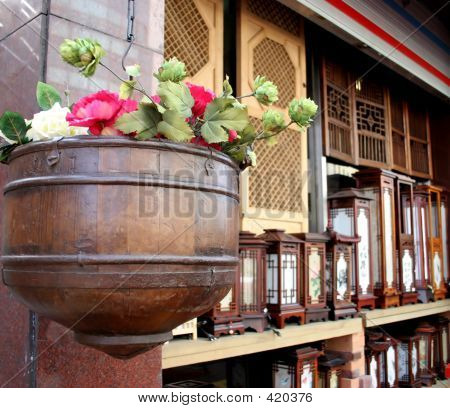 Flower Pot Hanging With Oriental Lights In The Background