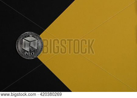 Neo Silver Coin On Black And Yellow Background. Banner With Place For Text And Light Beam. Crypto Co