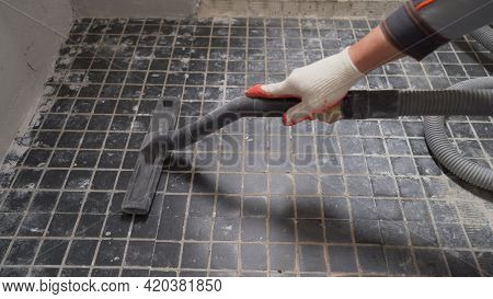 A Worker Is Cleaning Dust With A Vacuum Cleaner On The Floor. Cleaning Service. Dust Removal With Va