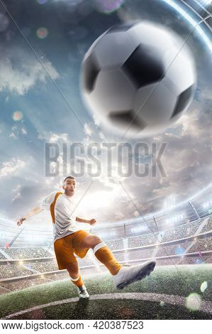 Power Soccer Kick. A Soccer Player Kicks The Ball In Stadium. Professional Soccer Player In Action. 
