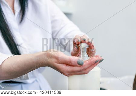 Girl Squeezes Shampoo On Her Hands. High Quality Photo