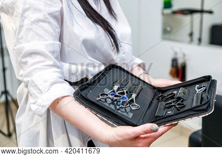 A Set Of Hairdresser Scissors, Combs, Razor