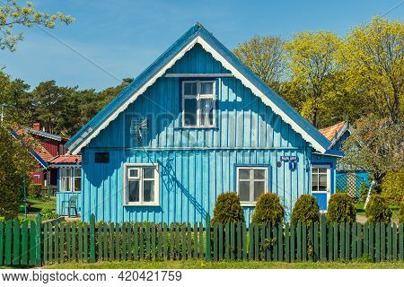 Nida, Lithuania - May 10 2021: Beautiful Old Lithuanian Traditional Wooden Light Blue House Of The C